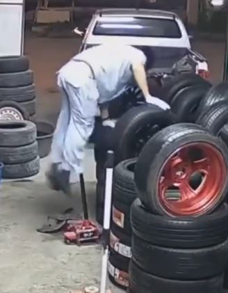Hilarious Fumble: Man’s Butt Meets Unfortunate Pole After Tire-Stack Climbing Mishap!
