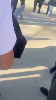 Sidewalk Girls Fight Next to Chain Linked Fence